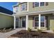 Inviting home entrance with a covered porch, white columns, and fresh landscaping details at 40 Rosewood Ln, Youngsville, NC 27596