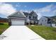 Charming two-story home with a two-car garage, manicured lawn, and inviting curb appeal at 40 Rosewood Ln, Youngsville, NC 27596