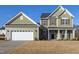 Charming two-story home with green siding, attached garage, and a well-maintained front yard at 40 Rosewood Ln, Youngsville, NC 27596