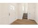 Entryway featuring wood flooring, white door, and staircase at 40 Rosewood Ln, Youngsville, NC 27596