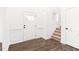 Bright foyer with hardwood floors, a staircase, and paneled walls at 40 Rosewood Ln, Youngsville, NC 27596