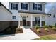 Inviting front porch with brick accents and white columns at 40 Rosewood Ln, Youngsville, NC 27596