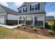 Inviting front porch with decorative columns and manicured landscaping offers a warm welcome at 40 Rosewood Ln, Youngsville, NC 27596