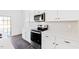 Bright kitchen with white cabinets, stainless steel appliances, and tile backsplash at 40 Rosewood Ln, Youngsville, NC 27596
