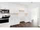 Well-lit kitchen featuring modern appliances, white cabinets, and hardwood floors at 40 Rosewood Ln, Youngsville, NC 27596