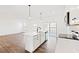 Open-concept kitchen with island, hardwood floors, and stainless steel appliances at 40 Rosewood Ln, Youngsville, NC 27596