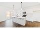 Modern kitchen with white cabinets, quartz countertops, and stainless steel appliances at 40 Rosewood Ln, Youngsville, NC 27596