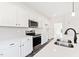 Modern kitchen featuring stainless steel appliances, white quartz countertops, and ample cabinet space at 40 Rosewood Ln, Youngsville, NC 27596