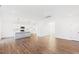 Spacious living room with hardwood floors, large windows, and open to kitchen with modern lighting at 40 Rosewood Ln, Youngsville, NC 27596
