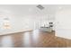 Bright living room with hardwood floors, large windows, and open-concept design into kitchen at 40 Rosewood Ln, Youngsville, NC 27596