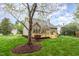Back exterior view of the home, with a deck and landscaped yard and tree shading at 401 Stinhurst Dr, Durham, NC 27713