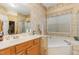 Bathroom features patterned wallpaper, vanity sink, and a large jacuzzi tub at 401 Stinhurst Dr, Durham, NC 27713