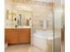 Bathroom features patterned wallpaper, vanity sink, jacuzzi tub, and glass shower at 401 Stinhurst Dr, Durham, NC 27713