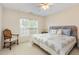 Bright bedroom with a window, ceiling fan, and a comfortable bed at 401 Stinhurst Dr, Durham, NC 27713