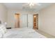 Bedroom featuring neutral walls, white bedding, and access to the bathroom and closet at 401 Stinhurst Dr, Durham, NC 27713