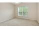 Bedroom featuring neutral carpet, large window, and light walls at 401 Stinhurst Dr, Durham, NC 27713