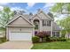 Charming two-story home with a well-manicured lawn and a two-car garage at 401 Stinhurst Dr, Durham, NC 27713