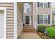 Inviting front entrance with brick steps and decorative plants leading to the front door at 401 Stinhurst Dr, Durham, NC 27713