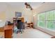 Home office area with a desk, shelving, ceiling fan and a window at 401 Stinhurst Dr, Durham, NC 27713