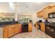 Well-lit kitchen with stainless steel appliances and a view of the dining area at 401 Stinhurst Dr, Durham, NC 27713