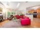 Open living room with a fireplace, hardwood floors, and a view into the kitchen at 401 Stinhurst Dr, Durham, NC 27713