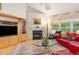 Cozy living room featuring a fireplace, large windows, and hardwood floors at 401 Stinhurst Dr, Durham, NC 27713