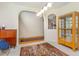 Open living room with carpet flooring, wood cabinet, and an arched entry at 401 Stinhurst Dr, Durham, NC 27713