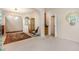 Open living room with carpet flooring, a glass display case, and an arched entry at 401 Stinhurst Dr, Durham, NC 27713