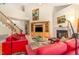 Bright living room with high ceilings, a fireplace, and an adjacent staircase at 401 Stinhurst Dr, Durham, NC 27713