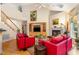 Spacious living room with fireplace, hardwood floors, and abundant natural light at 401 Stinhurst Dr, Durham, NC 27713
