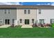 Green backyard featuring lawn with patio and townhouse exterior at 41 Willow Green Dr, Clayton, NC 27527