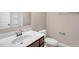 Bathroom with a white sink, stained wood vanity, toilet, mirror, and towel bar at 41 Willow Green Dr, Clayton, NC 27527
