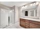 Bathroom featuring a double vanity with granite countertops and a glass-enclosed shower at 41 Willow Green Dr, Clayton, NC 27527