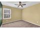 Bedroom with tan walls, carpet, ceiling fan and bright window at 41 Willow Green Dr, Clayton, NC 27527