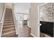 Open entryway featuring a carpeted staircase, wood-look floors, and a powder room at 41 Willow Green Dr, Clayton, NC 27527