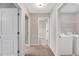 Hallway with carpet, showing doorways to bathroom and laundry room at 41 Willow Green Dr, Clayton, NC 27527