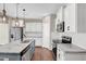 Bright, updated kitchen featuring white cabinets, stainless steel appliances, granite countertops, and an island sink at 41 Willow Green Dr, Clayton, NC 27527