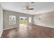 Bright living room with wood floors, ceiling fan, decorative chandelier, and sliding glass doors to the back yard at 41 Willow Green Dr, Clayton, NC 27527