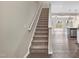 Carpeted staircase leading to the upper level, with modern wood-look flooring and an open-concept design at 41 Willow Green Dr, Clayton, NC 27527