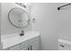 Updated bathroom features modern vanity, round mirror, and updated light fixture at 4101 Five Oaks Dr # 40, Durham, NC 27707