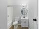 Updated bathroom features modern vanity, updated light fixture, shower, and toilet at 4101 Five Oaks Dr # 40, Durham, NC 27707