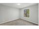 Bedroom with neutral paint, carpet, a window, and baseboard trim at 4101 Five Oaks Dr # 40, Durham, NC 27707