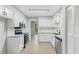 Well-lit kitchen with stainless steel appliances, white cabinets and modern fixtures at 4101 Five Oaks Dr # 40, Durham, NC 27707
