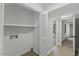 Hallway shows laundry hookups with shelving, as well as access to other rooms at 4101 Five Oaks Dr # 40, Durham, NC 27707