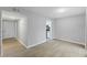 Open-concept living room features neutral paint, hardwood flooring, and access to kitchen at 4101 Five Oaks Dr # 40, Durham, NC 27707
