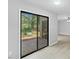 Living room featuring sliding glass doors with views of nature and wood-look floors at 4101 Five Oaks Dr # 40, Durham, NC 27707