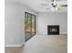 Living room features fireplace, ceiling fan, wood-look flooring, and sliding glass doors at 4101 Five Oaks Dr # 40, Durham, NC 27707