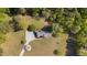 Aerial view of charming home with a gravel driveway, expansive lawn, and mature trees at 413 Bayles Rd, Lillington, NC 27546