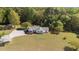 Aerial view of ranch home, long drive, nice landscape and wooded lot at 413 Bayles Rd, Lillington, NC 27546