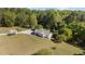Aerial view of ranch home, long drive, nice landscape and wooded lot at 413 Bayles Rd, Lillington, NC 27546